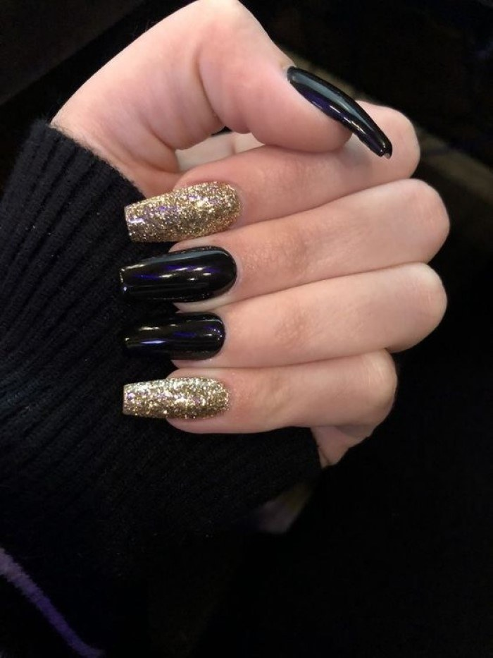 Black nail design mixed with luxurious sparkling gold