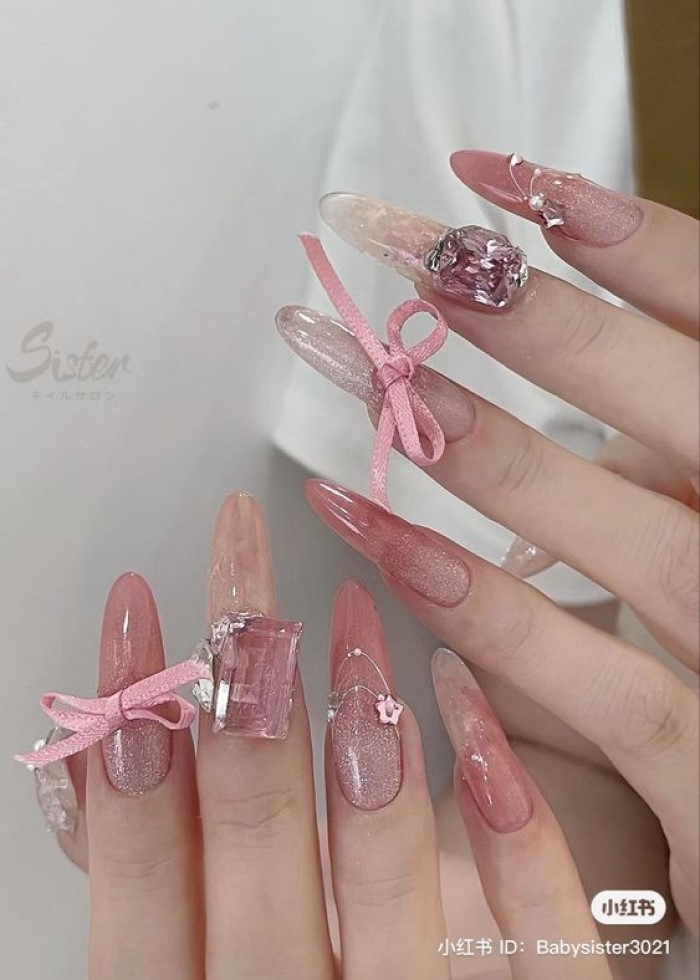 Pink nails with stones and bows