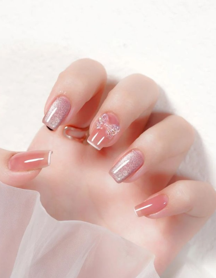 Earthy orange jelly nail polish color with cat eye and cute bow tie
