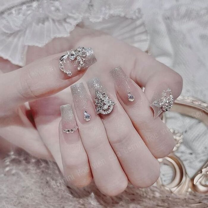 The bride's nails are completely studded with sparkling stones