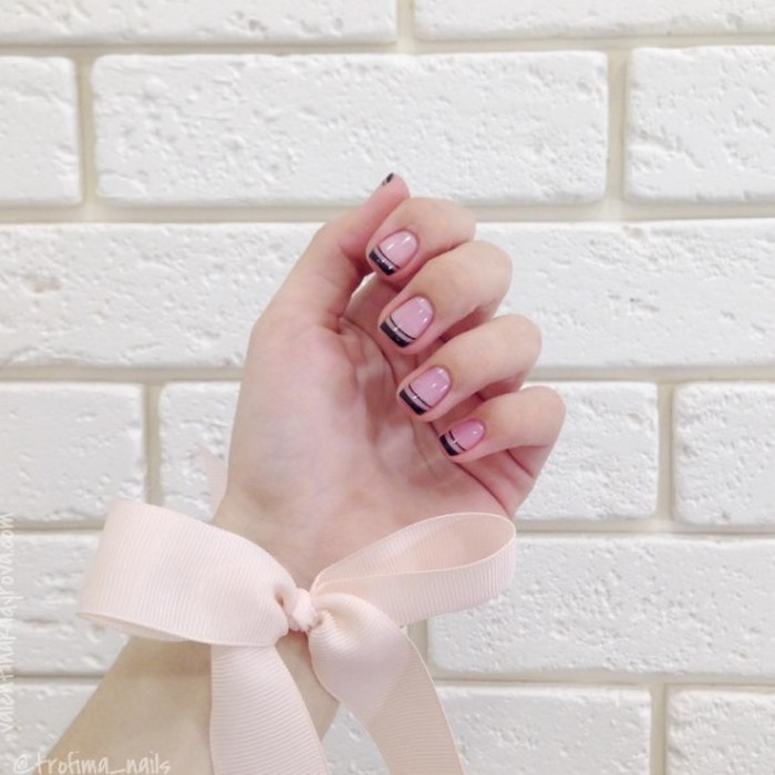 Suggested round pink nails with black motifs