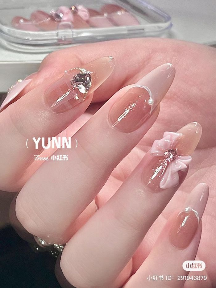 Pink rhinestone nail design with bright stones