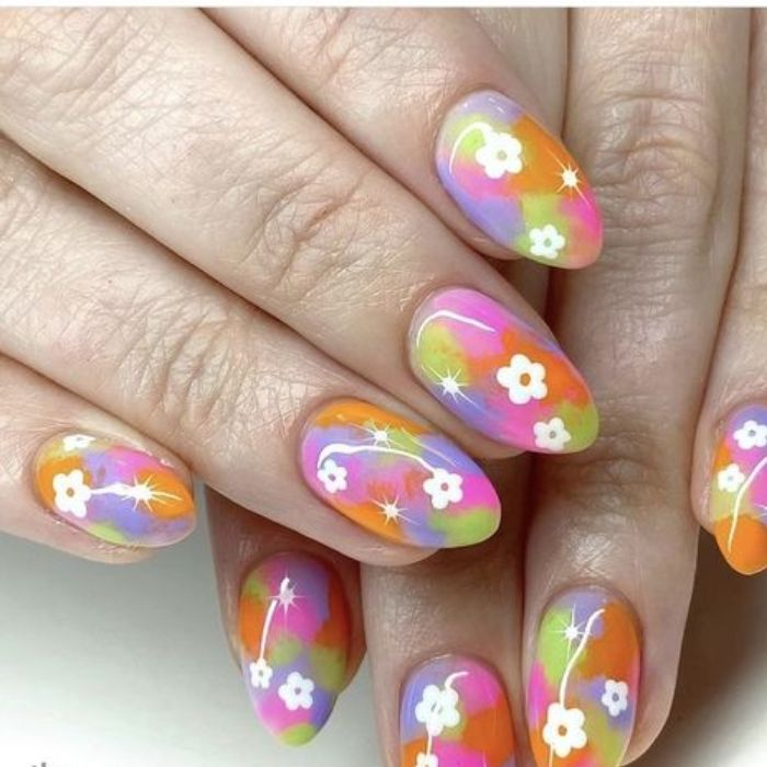 Colorful rainbow nail designs with floral accents, white accents, minimal styling — design 2