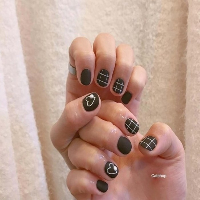 Short black nails combined with heart drawings