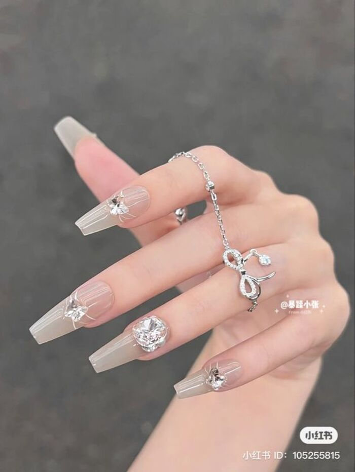 Beautiful white nails with sparkling stones