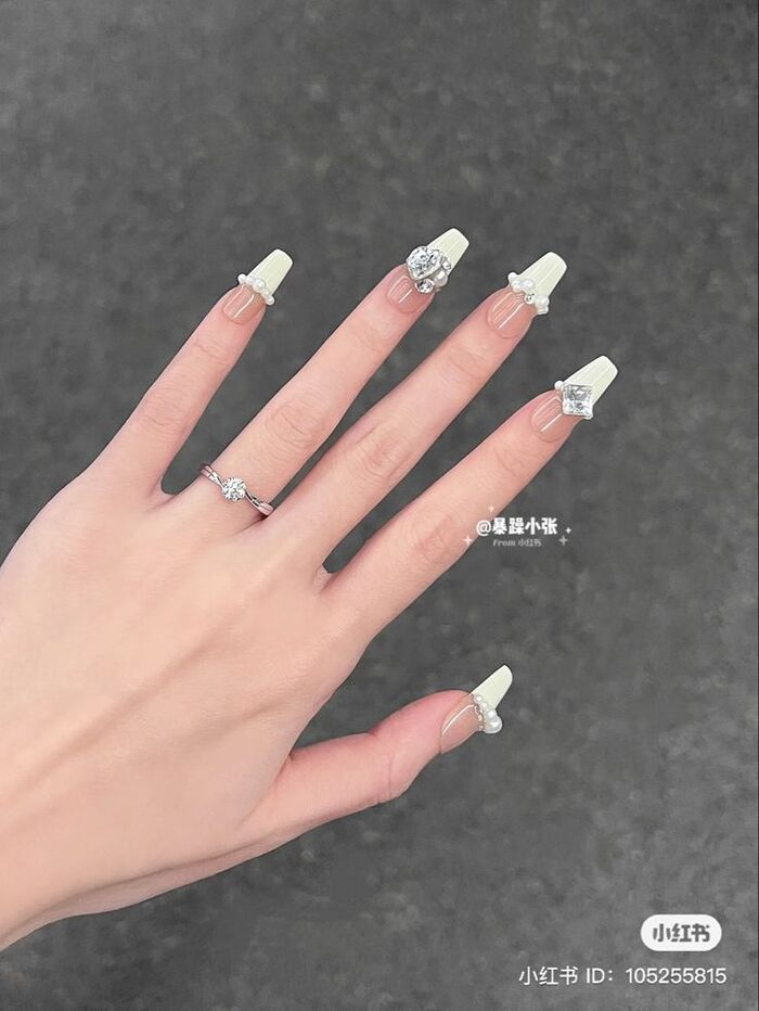 Clear white nail design with beautiful stone motifs