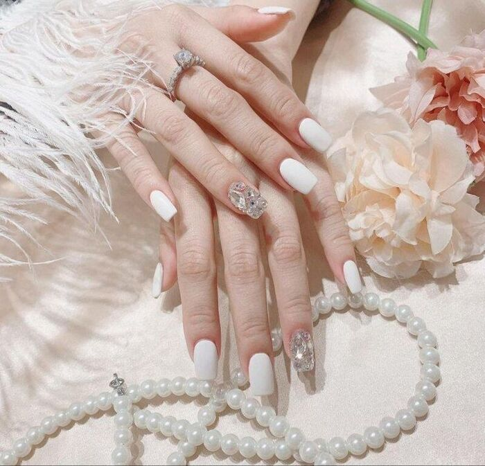 Beautiful white nail design with stones