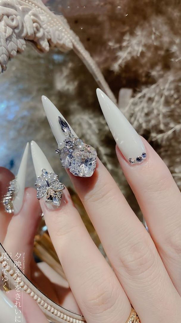 Collection of white nail polish with striking large stones