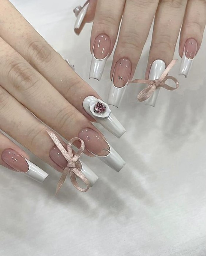 Beautiful nails with gentle fabric bows attached