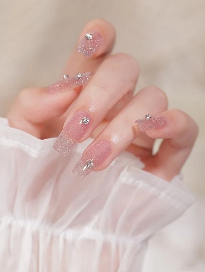 Sparkling stones on cute pink nails