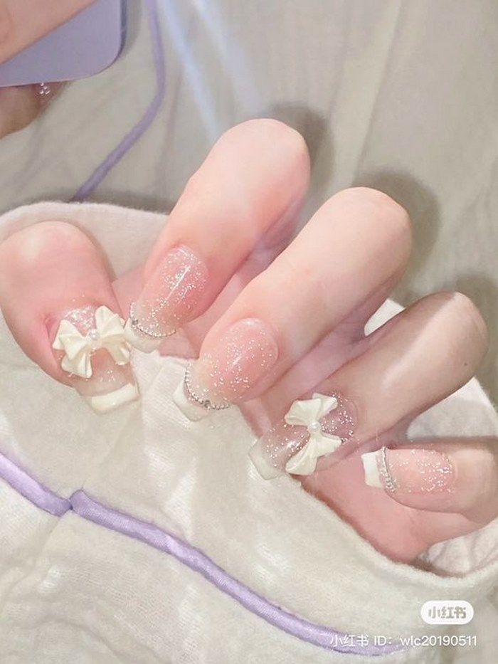 Soft pink jelly nail designs with glitter, bow charms, cute styling — design 96