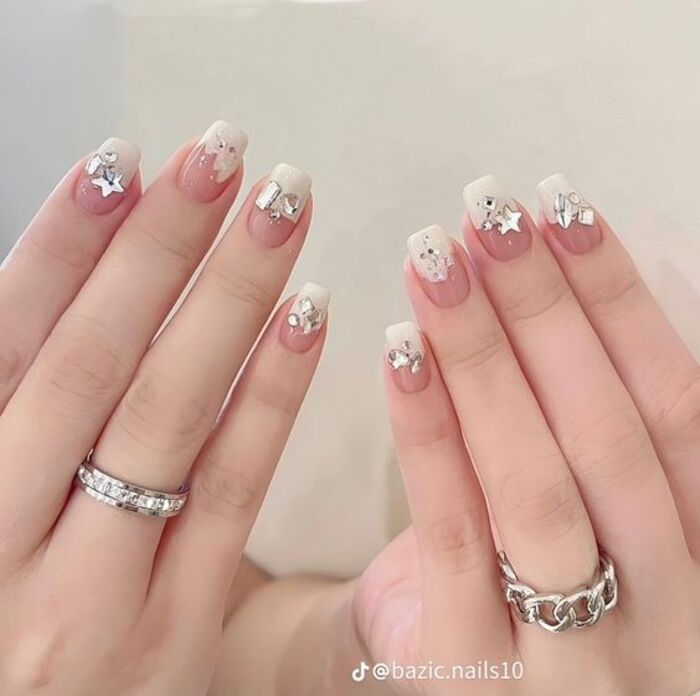 Simple bridal nail design in pink mixed with white and studded with stones