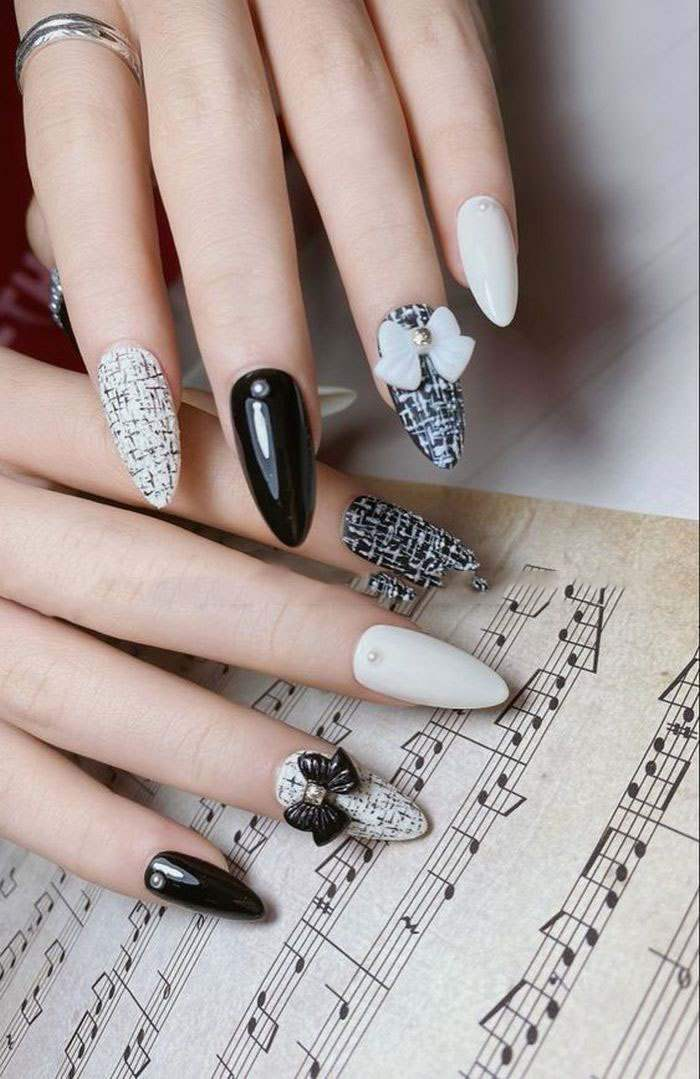 Beautiful, ladylike nail design with bow charm