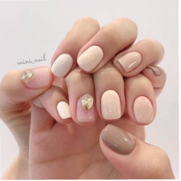Pink and white short nail design with stones