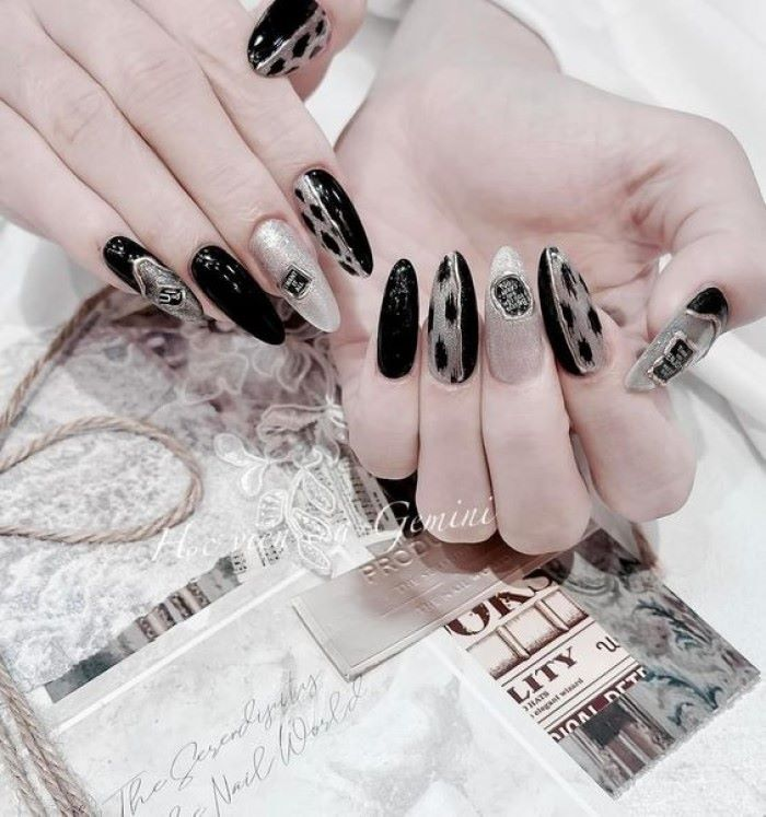 Black nail design with luxurious patterns