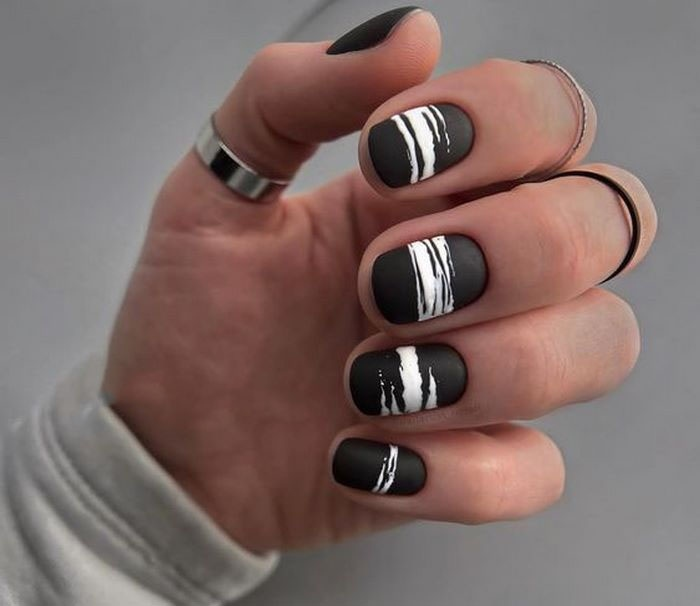 Suggested motifs painted on black background nail designs