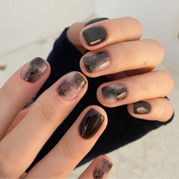 Simple black nail design with stone patterns