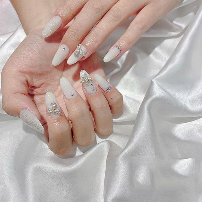 White nail color tone combined with stones