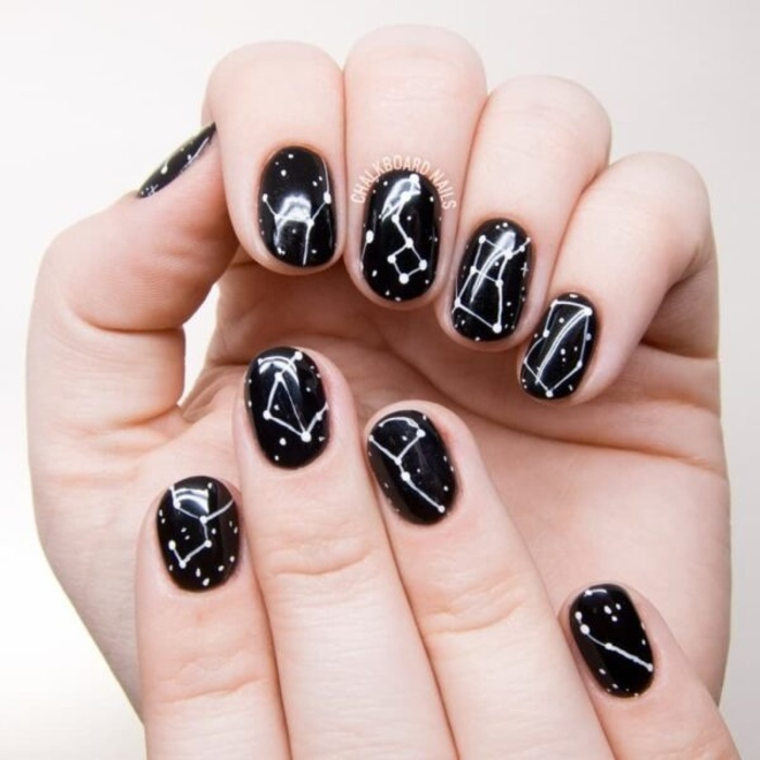 Short black nails depicting the North Star constellation