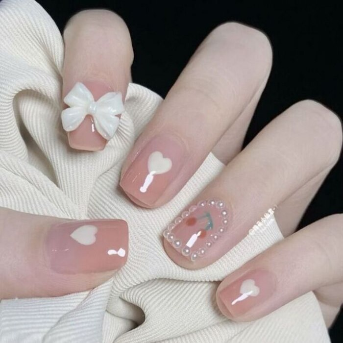 Suggested light pink round nail design with sparkling stones
