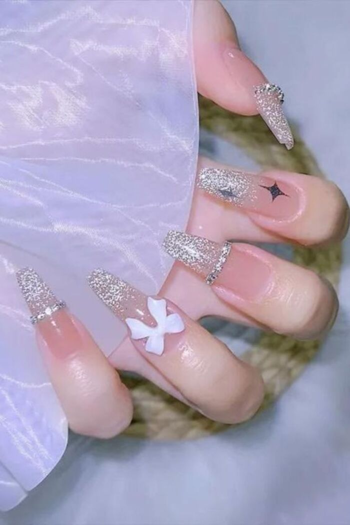 The bride's nail design is gentle but still sparkling