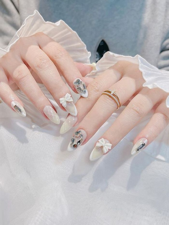 Attach a lovely bow to your nails to add a cute touch