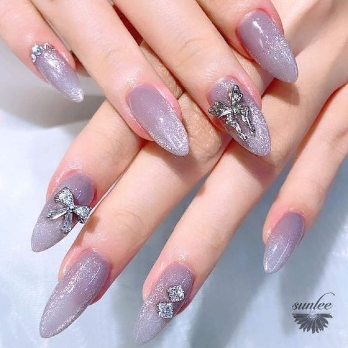 Long, round, pointed purple nails hide cat eyes