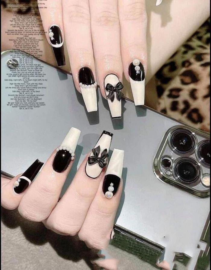 Luxurious black and white nail polish gives her more confidence