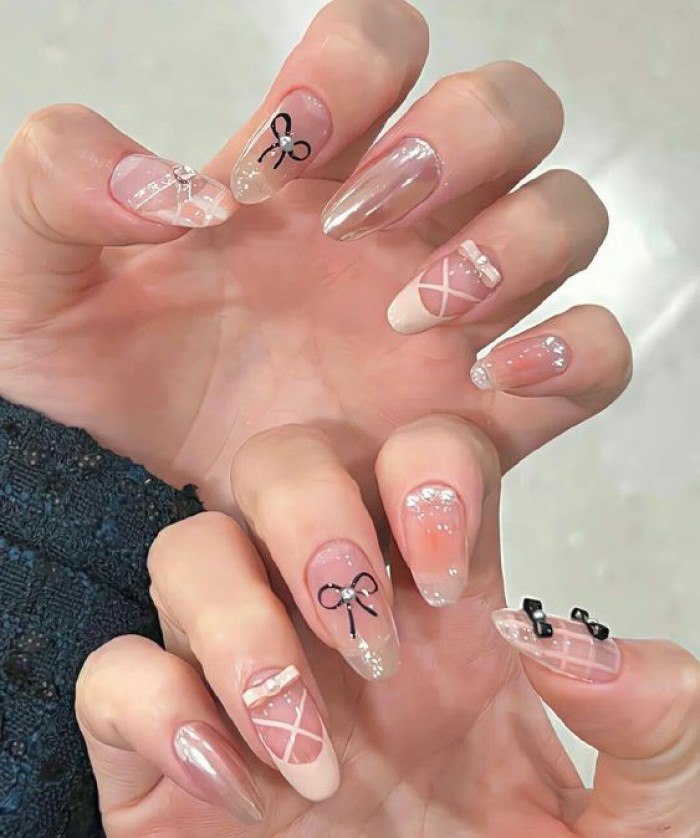 Beautiful pink pointed nails with simple black and white combination