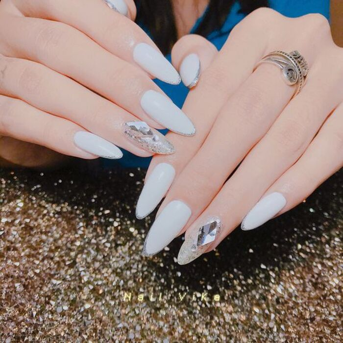 White bridal nail style with beautiful stones