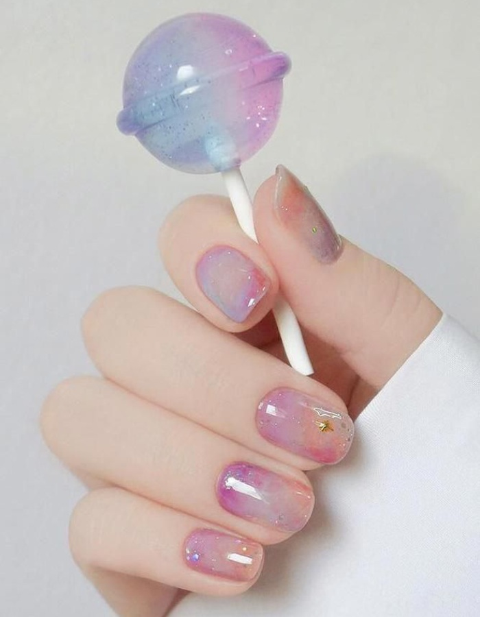 Beautiful rhinestone nails with unique galaxy theme