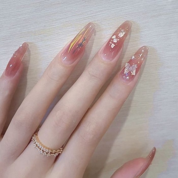 Round and square nail design with pink stones