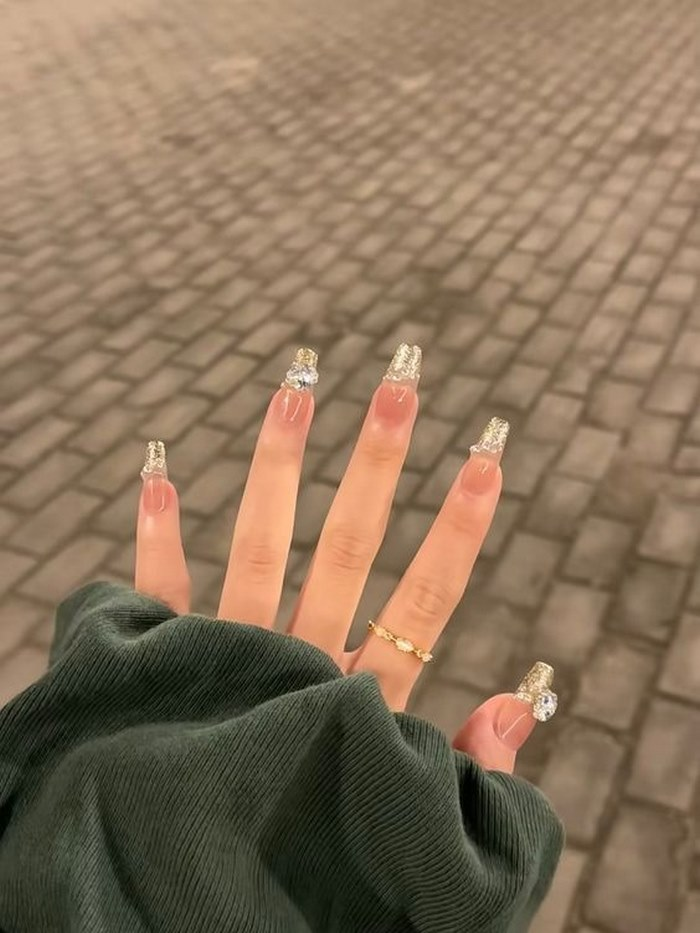 Pink nail design with stones is extremely flattering for her skin