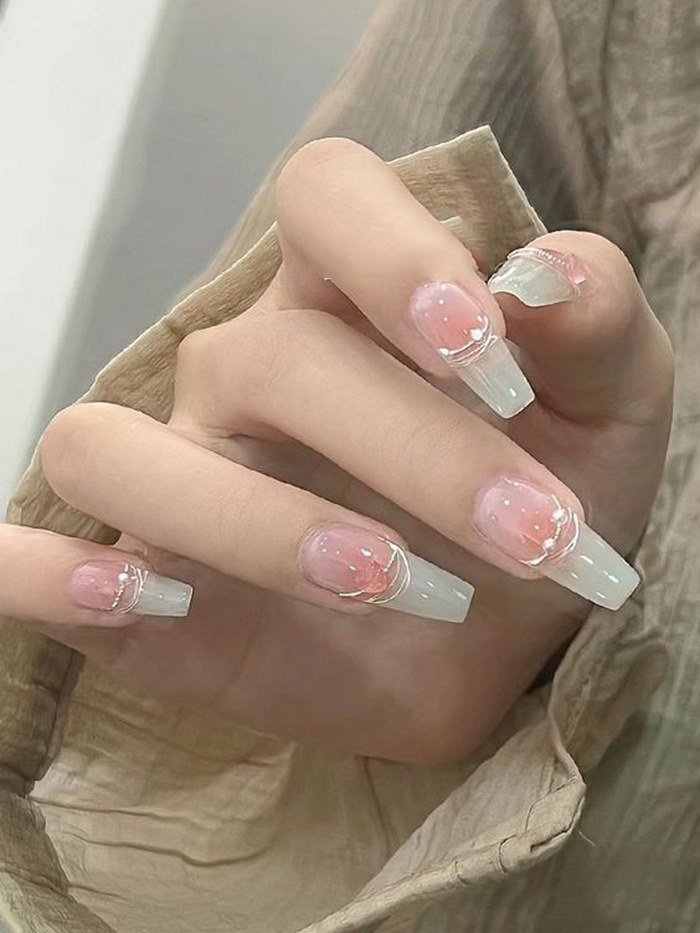 Pink rhinestone nails with stones create attractive hands