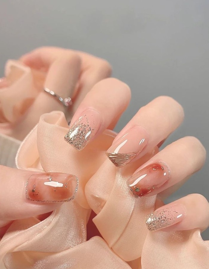 Beautiful transparent jelly nails mixed with earthy orange and gentle glitter